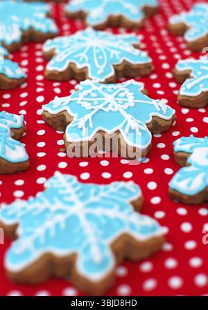 Many snowflake shaped cookies on the red tablecloth Stock Photo