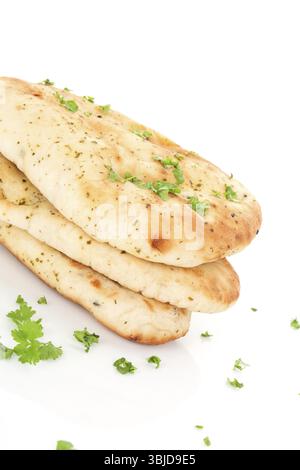Culinary naan flatbread stack with fresh parsley isolated on white background. Traditional eastern bread eating Stock Photo