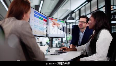 Multiracial Manager Uses Kanban Software On Laptop To Schedule Project. Stock Photo