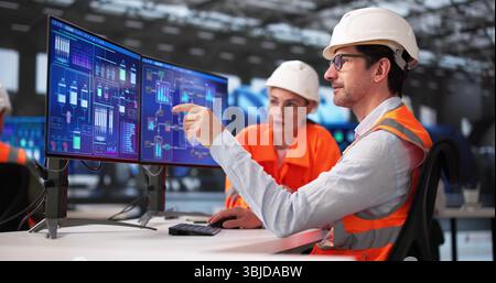 Diverse Group Of African American Engineers Monitor Gas Control System. Stock Photo