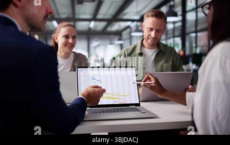 Multiracial Team Using Calendar Software To Meet Project Deadline Stock Photo