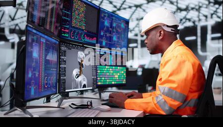 American Engineer Creating Futuristic Robot In Black Office Using 3D CAD Software Stock Photo