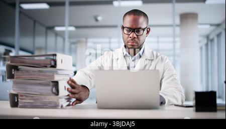 Medical Records Transformation: Young Accountant Digitizing Invoices On Computer Stock Photo