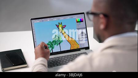 Young African American Man Edits Colorful Graphic Designs On Laptop. Stock Photo