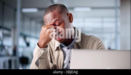 Frustrated Accountant At Desk With Sinus Pressure, Feeling Overwhelmed And Stressed. Stock Photo