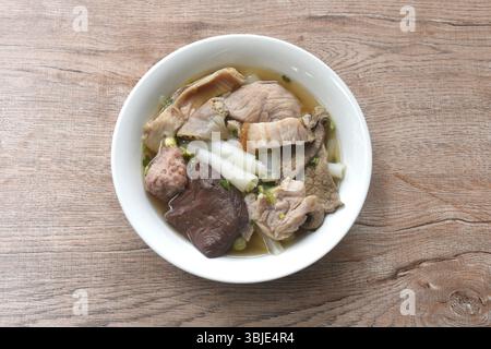 large rice noodles chop and crispy pork topping blood in clear soup on bowl Stock Photo