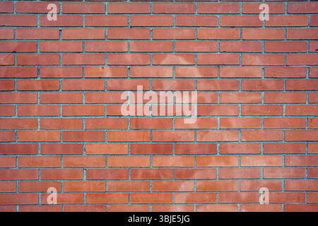 Background made of an ordinary red brick wall Stock Photo