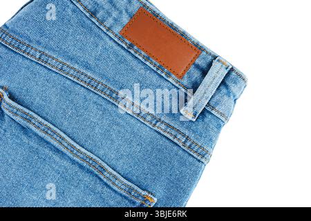 Back side pocket and waistband detail from casual wear design of blue jeans pants closeup, isolated on white background. Fashion concept, shopping, sa Stock Photo