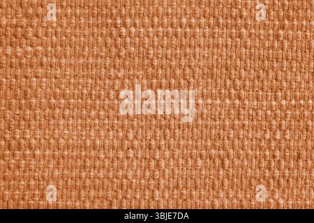 Texture of orange natural fabric with large weaving. Surface, structure of upholstery or carpet material, cloth background close up. Stock Photo