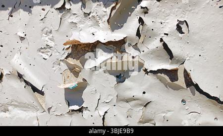A closeup of peeling white paint showcasing urban decay and intricate textures in an artistic manner Stock Photo