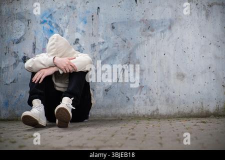 A Man Feeling Depressed and Anxious, Covering His Face In His Hands Stock Photo