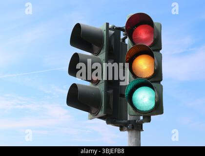 Traffic light isolated in the sky with all lights on. Stock Photo