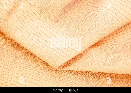 Yellow color artificial crocodile leather texture as background. Stock Photo