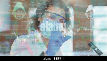 Lab scientist wearing PPE observing microscope sample at lab bench with data charts and figures Stock Photo