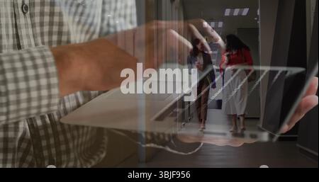 Typing man's hands pressing keys on laptop keyboard in office hallway, with disposable coffee cups Stock Photo