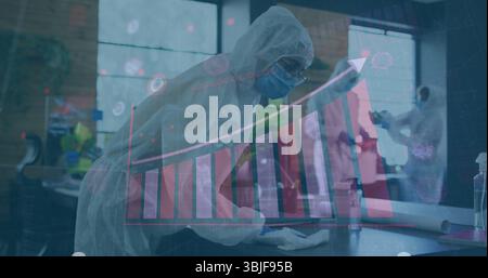 Wiping central figure using spray bottle and cloth wearing protective gear in lab, chart overlay Stock Photo
