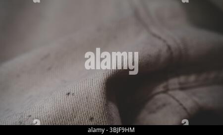 Close-Up of Beige Fabric with Seam and Texture Stock Photo