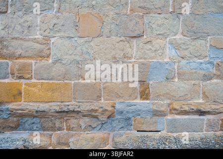 Old stone  Wall with Lots of Texture and Color. Abstract pattern of an old red, orange and black brick wall with lots of texture useful for background Stock Photo
