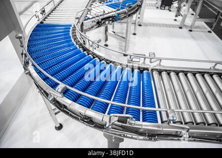 Empty modern conveyor belt of production line, part of industrial equipment in factory plant. Automatic system line Stock Photo