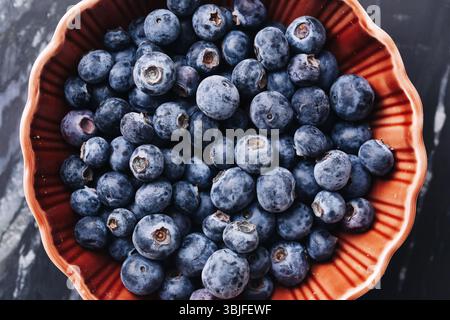 Fresh blueberries in bowl. Healthy fruit snack. Organic antioxidant food. Marble background. Natural sweet berries. Vegan lifestyle ingredients. Stock Photo