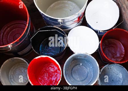 Empty paint buckets with drips, top view. Stock Photo