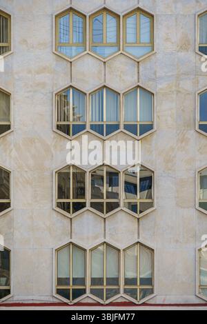 Modern Honeycomb Facade with Hexagonal Windows on a Contemporary Building. Abstract Architecture, Geometric Design, Urban Exterior, Unique Pattern Stock Photo