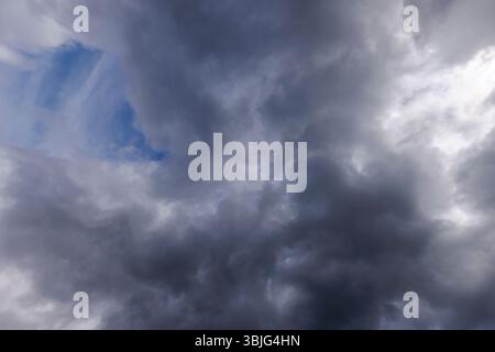Gray cirrostratus clouds covering almost all the sky, small glimpse of blue sky behind clouds, Finland Stock Photo