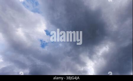 Gray cirrostratus clouds covering almost all the sky, small glimpse of blue sky behind clouds, Finland Stock Photo