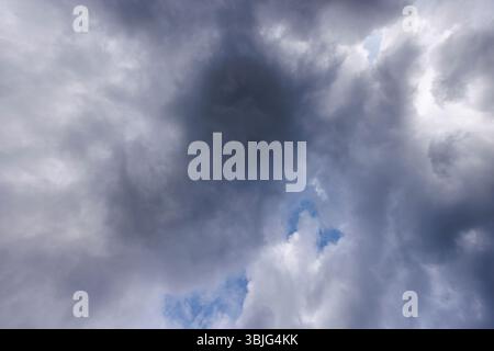 Gray cirrostratus clouds covering almost all the sky, small glimpse of blue sky behind clouds, Finland Stock Photo