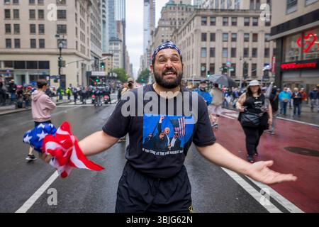 NEW YORK, NEW YORK - JUNE 14: ?A Trump supporter taunts anti-Trump Protesters during the 'No Kings Day' protest?, as tens of thousands march along Fifth Avenue on June 14, 2025 in New York, New York. Hundreds of marches and protests? sprang up ?across the United States as part of a "national day of peaceful protest" against the Trump administration? and his policies. The national protest comes as President Donald Trump's military parade celebrating the 250th anniversary of the U.S. Army is taking place in Washington, DC. Today's parade coincides with President Trump's birthday. ?(Photo by Mic Stock Photo