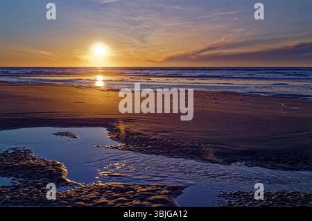 Sunset over a sandy beach at low tide, Juist, Aurich, East Frisia, Lower Saxony, Germany Stock Photo