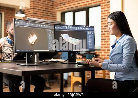 Professional female engineer manufacturing machinery models with advanced CAD software. Asian woman technician sitting at desk and designing mechanical products on a digital interface. Stock Photo