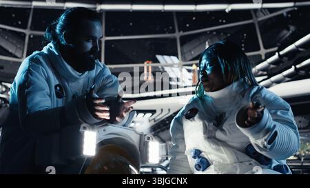 Teamworking cosmonauts chatting, exploring deep space during mankind survival expedition. Astronauts doing human expansion in space mission in spacecraft powered by advanced engineering Stock Photo