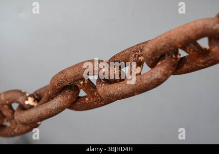 The rusty but fully operational anchor chain on board of offshore support vessel. Anchor is used to keep the ship in position without engines Stock Photo