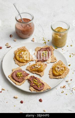 Buckwheat crackers with spread on a plate – a healthy, gluten-free snack or light lunch idea, perfect for clean eating, modern diets, and food styling. Stock Photo