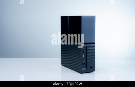 Black solid state external hard drive on white background, perfect for digital data storage and fast backup solutions in modern offices, tech workspac Stock Photo