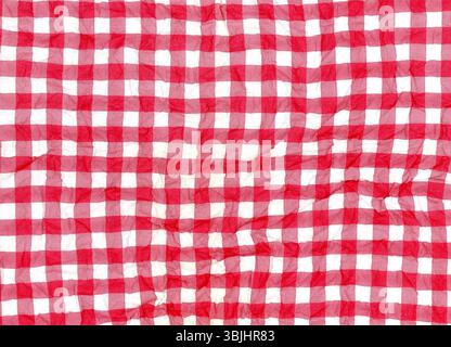 Creased red and white gingham pattern paper napkin texture background detail Stock Photo