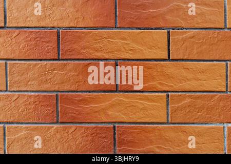 Textured Red Brick Wall Background. A high-quality image of a red brick wall displaying its distinct texture and pattern. Stock Photo