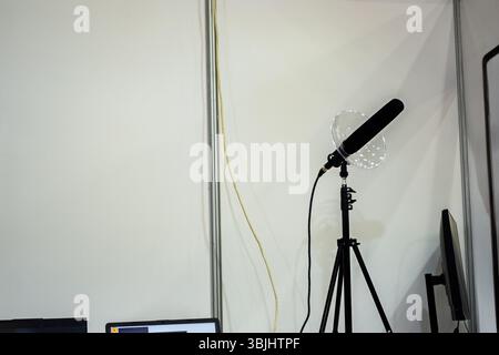 A specialized directional microphone with a clear parabolic shield on a tripod, designed for UAV detection and spectral analysis in an outdoor setting Stock Photo