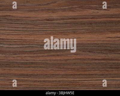 Cascading waves of caramel and coffee dance across the robust rosewood veneer's surface Stock Photo