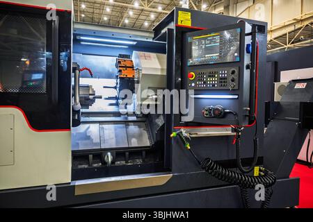 Complex industrial metalworking machine with high precision at a factory with a CNC control panel. Stock Photo