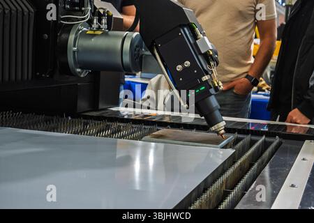 Industrial Precision Laser Cutting Machine at Work Manufacturing Metal Parts with High Accuracy and Efficiency. Stock Photo