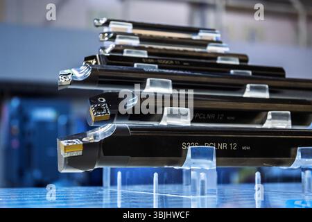 Precision CNC lathe cutting tools with carbide inserts displayed on stands, professional machining equipment for metal turning operations in modern ma Stock Photo