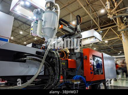 Plastic Injection Molding Machine Automated Molding Cell. Stock Photo