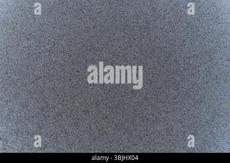 High-resolution close-up of natural beach sand texture. Ideal for use in backgrounds, design projects, digital textures, or nature-themed content. Stock Photo