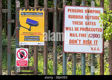 Signs to deter people from fly tipping, dumping rubbish Stock Photo