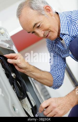 portrait of senior man operating machine Stock Photo