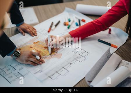 Collaborative Design Session Between Professionals Working on Architectural Plans Stock Photo