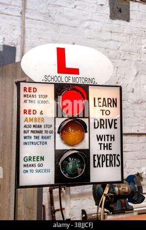 Vintage traffic light sign at a driving school, highlighting instructions for learning to drive with expert guidance Stock Photo