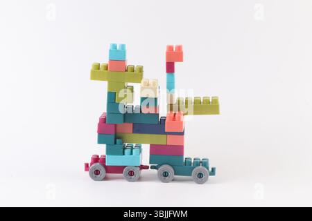 Plastic building blocks form vehicle on white background Stock Photo